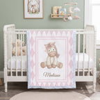 Personalized pink pony minky blanket draped on crib in woodland nursery