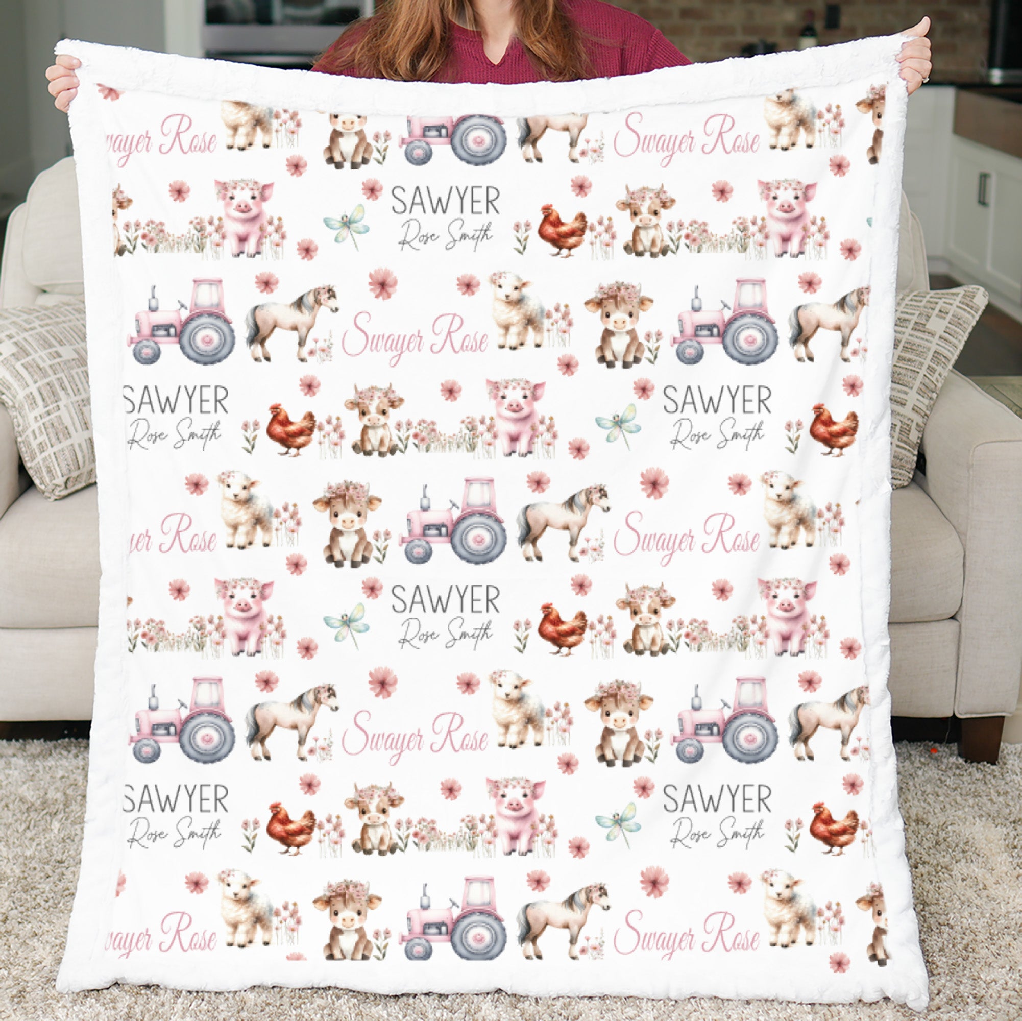 Flat lay of personalized pink tractor farm animal minky baby blanket with embroidered name