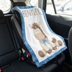 Personalized pony baby blanket with blue minky trim draped over car seat