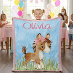 Personalized pony minky baby blanket with custom name, held by toddler girl at birthday party
