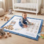 Baby sitting on personalized pony milestone blanket with toys in nursery