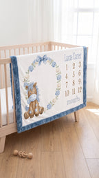 Personalized pony milestone minky blanket with blue trim hanging on crib rail