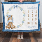 Personalized pony milestone minky blanket with blue trim shown by boy by fireplace