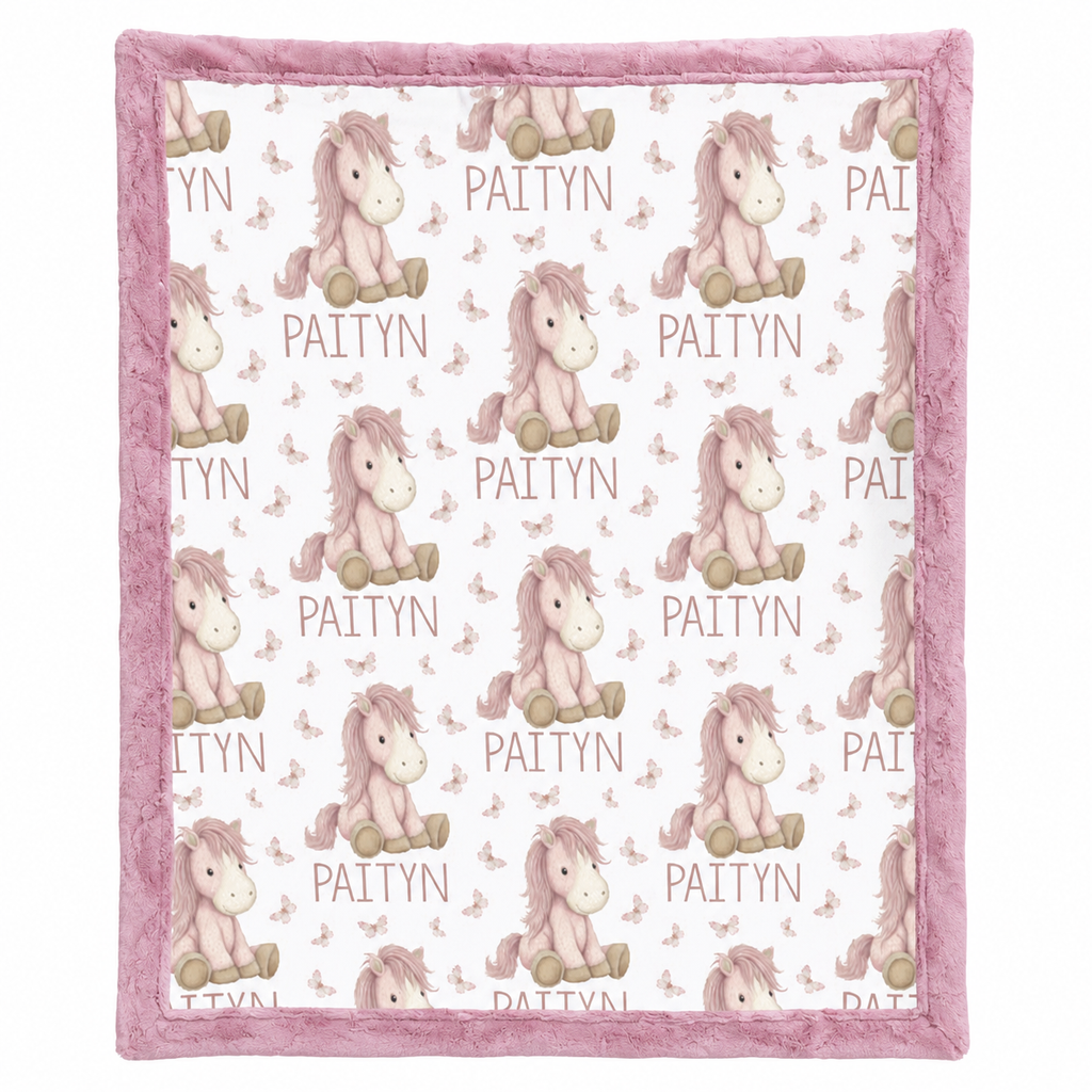Close-up of personalized pony name blanket pattern with pink minky trim