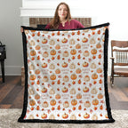 Woman holding personalized pumpkin patch minky blanket with custom name by fireplace, black trim