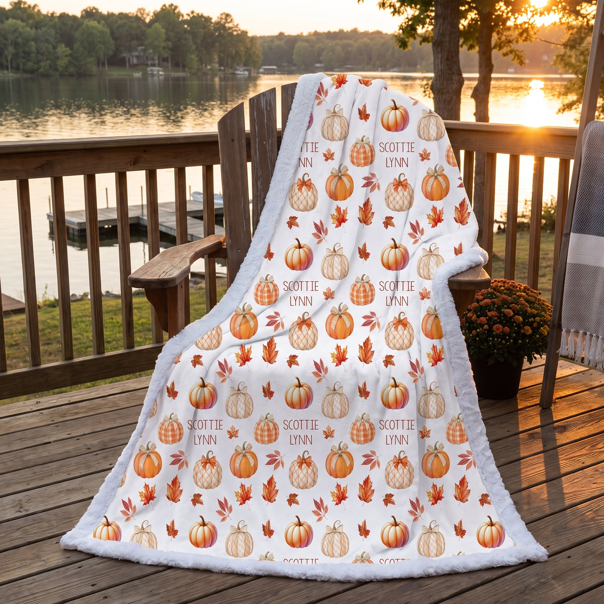 Personalized pumpkin patch minky blanket draped over porch chair at sunset by lake