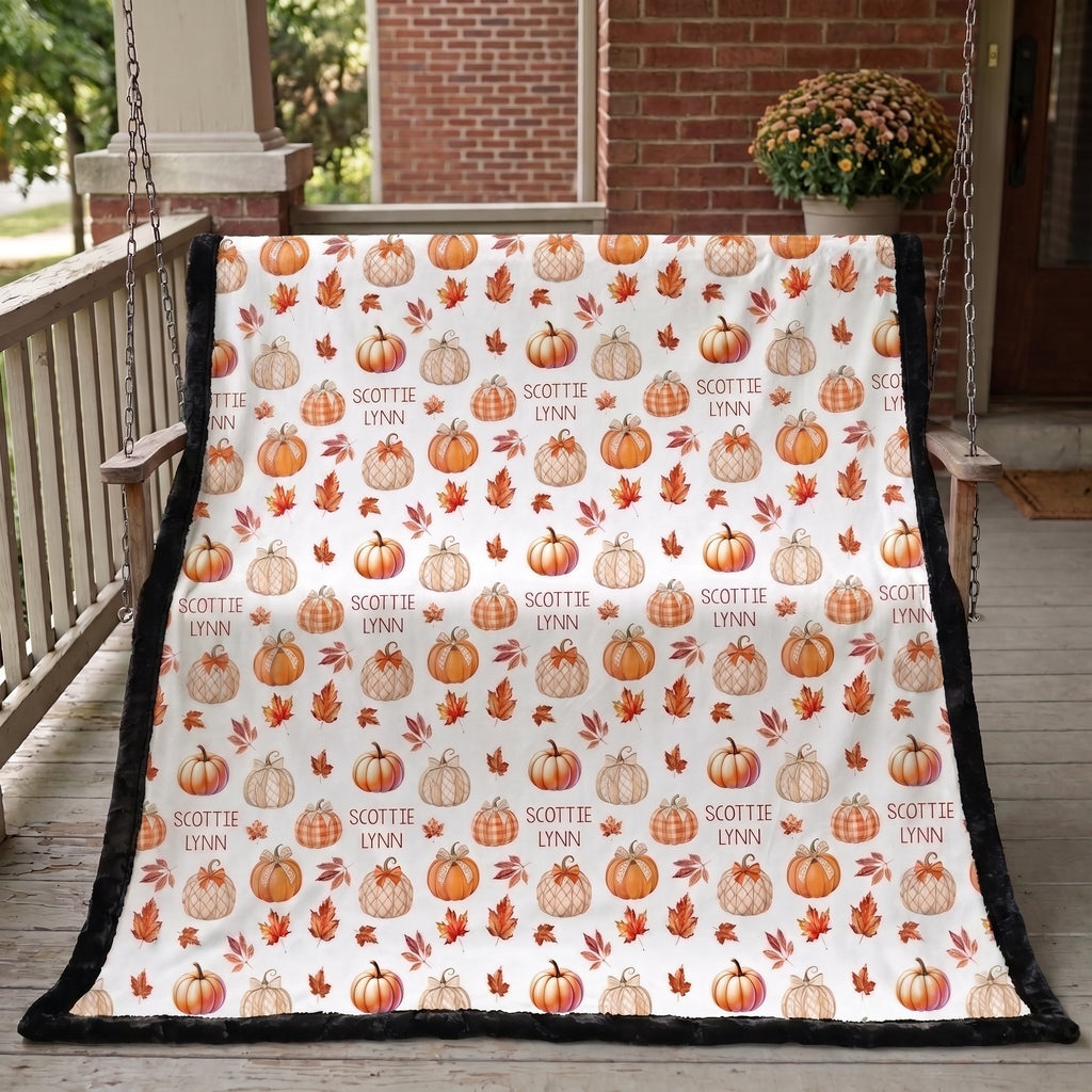 Personalized pumpkin patch minky blanket hanging on porch swing by brick house, black back