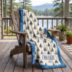 Personalized sailboat minky blanket draped over a porch chair overlooking a lake