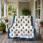 Personalized sailboat minky blanket draped over a white porch swing with ferns