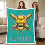 Two teen girls holding personalized teal softball minky blanket with Kensley name