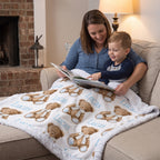 Personalized minky baby blanket with teddy bear print draped over mom and toddler's laps while reading
