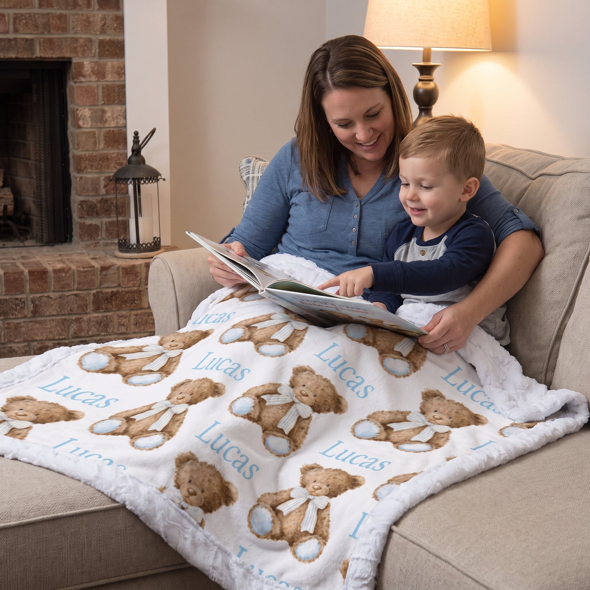 Personalized minky baby blanket with teddy bear print draped over mom and toddler's laps while reading