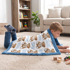 Boy wrapped in personalized teddy bear minky baby blanket while reading on the floor