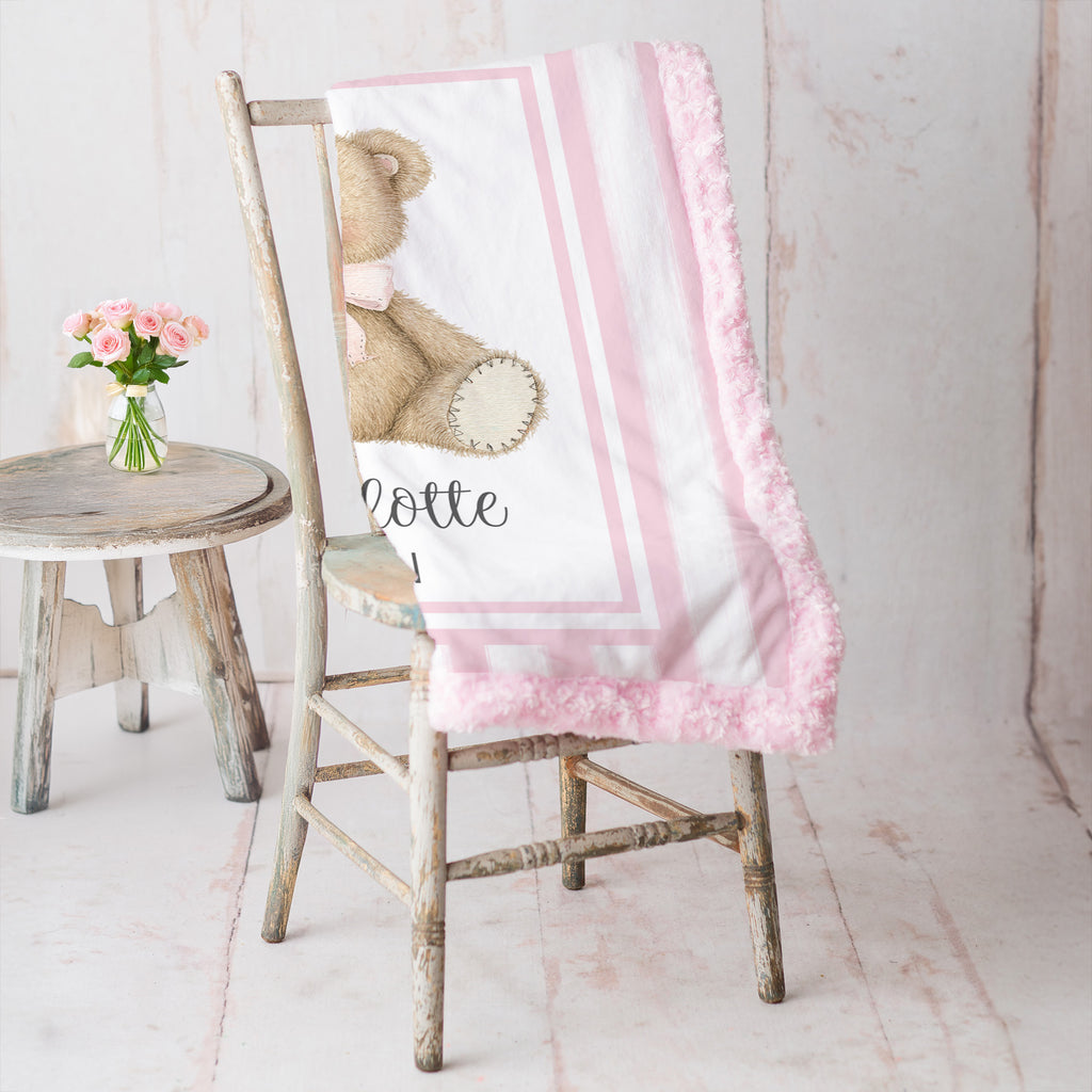 Personalized minky teddy bear baby blanket with pink rosette fur border on vintage chair