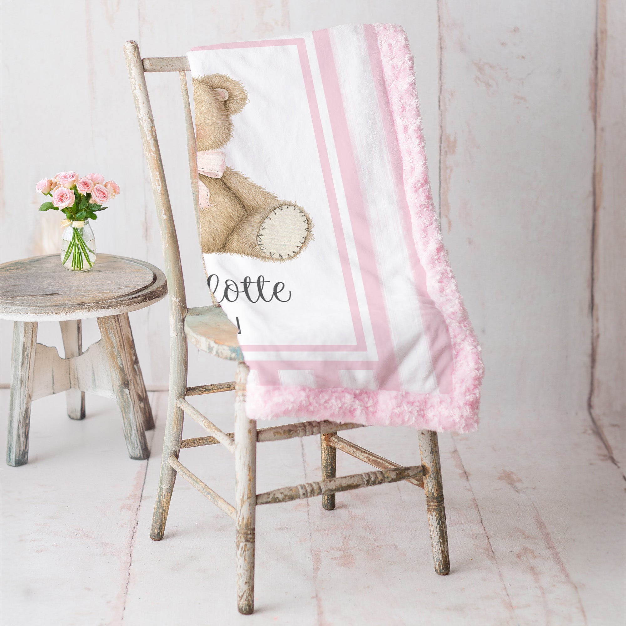 Personalized minky teddy bear baby blanket with pink rosette fur border on vintage chair