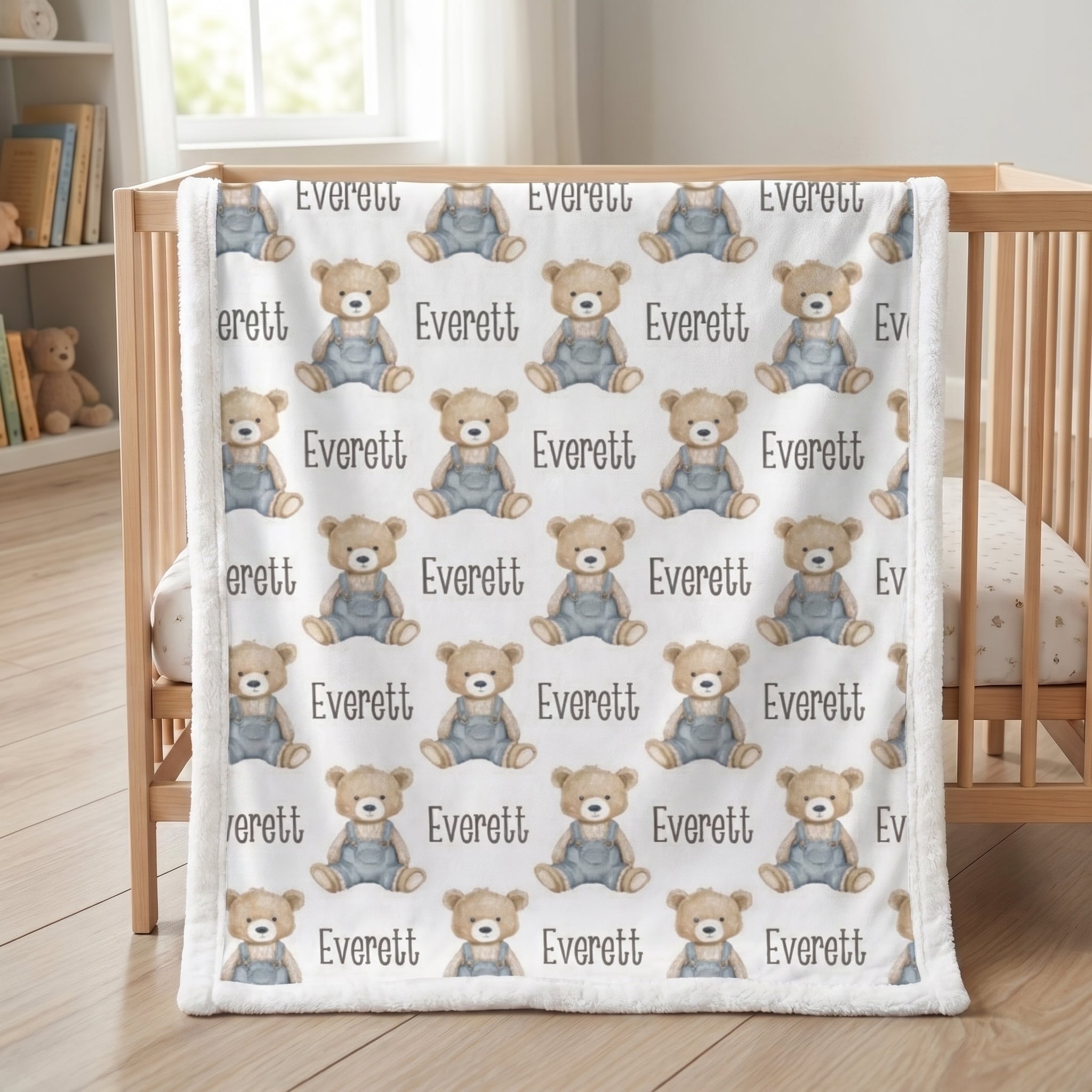 Personalized teddy bear minky baby blanket with white fur border draped over wooden crib in nursery