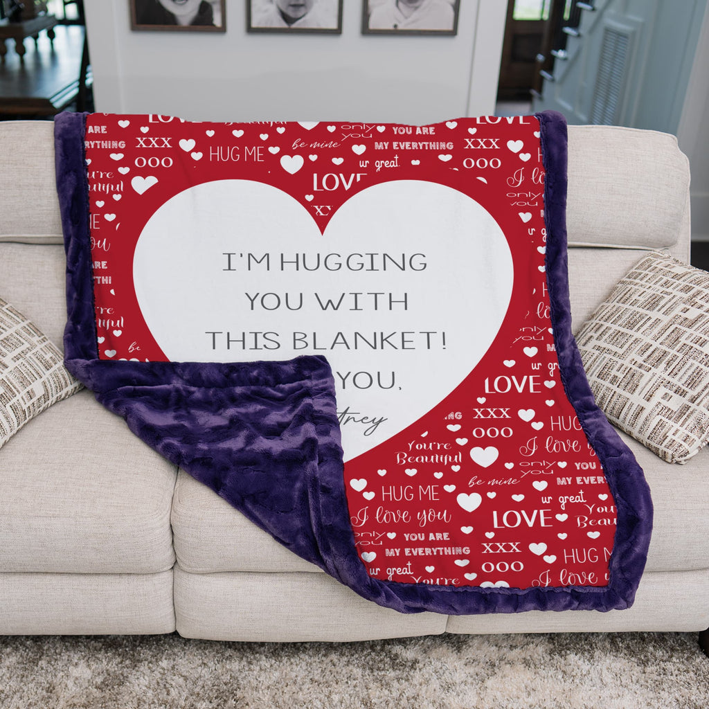 Red blanket with heart design and text on a couch