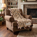 Personalized western horse blanket draped over armchair, cow print faux fur trim
