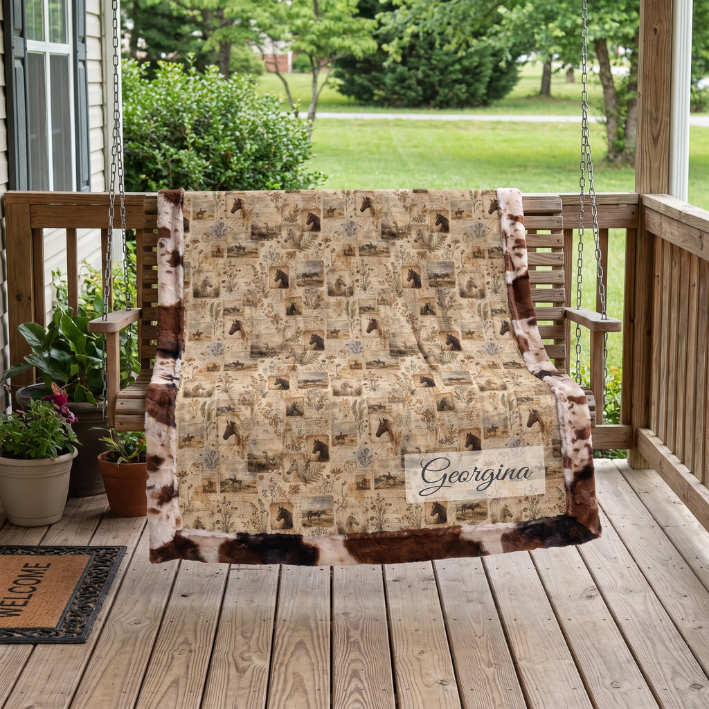 Personalized western horse blanket draped over porch swing, cow print faux fur trim