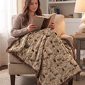 Woman reading with personalized western horse blanket over her lap, brown faux fur trim