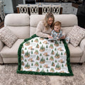 Mother and child reading together under personalized woodland animal minky blanket with green trim