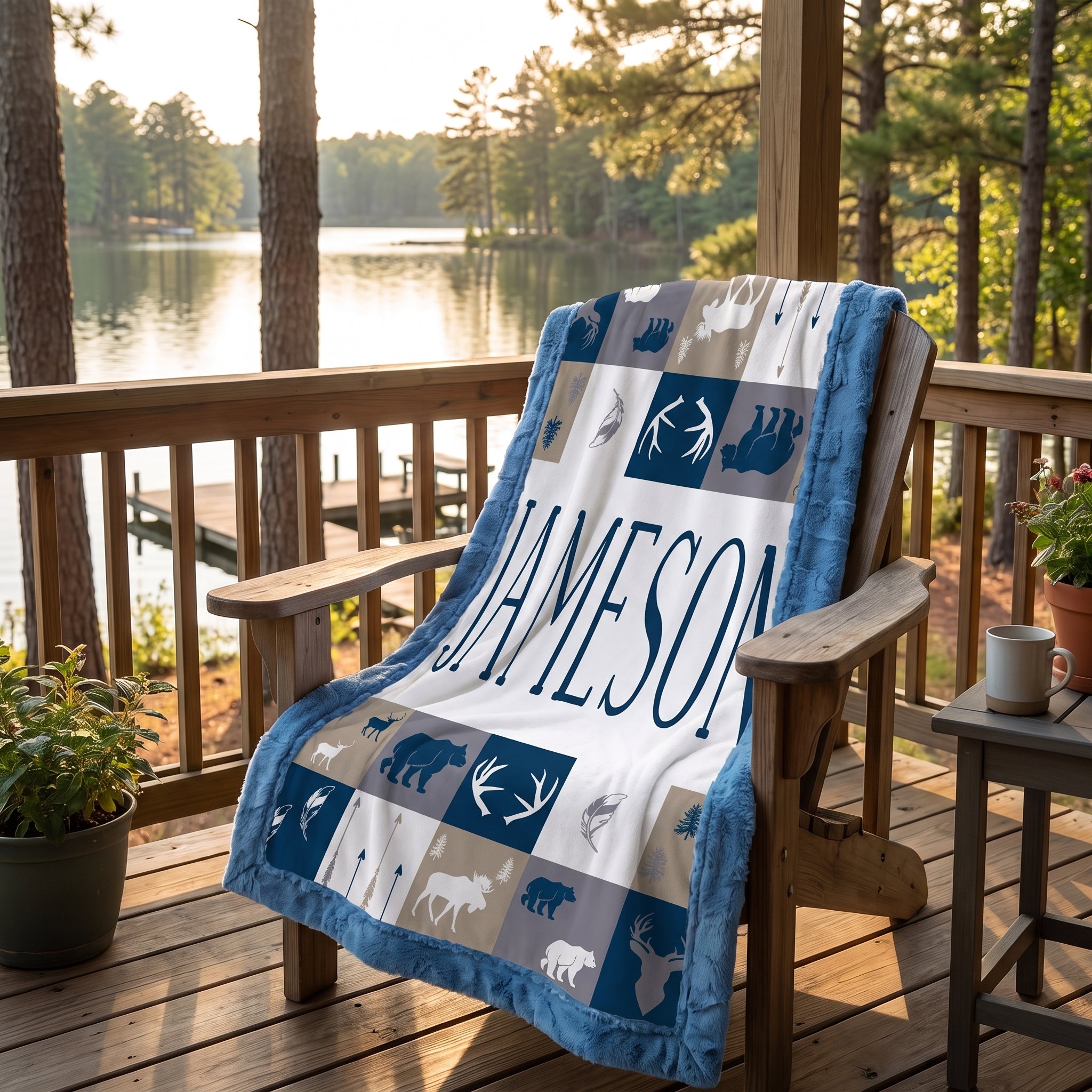 Personalized woodland minky blanket with blue trim draped over chair at lake dock