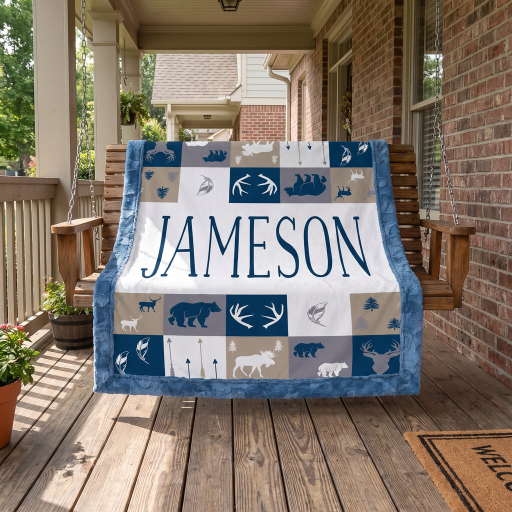 Personalized woodland minky blanket with blue trim draped over porch swing