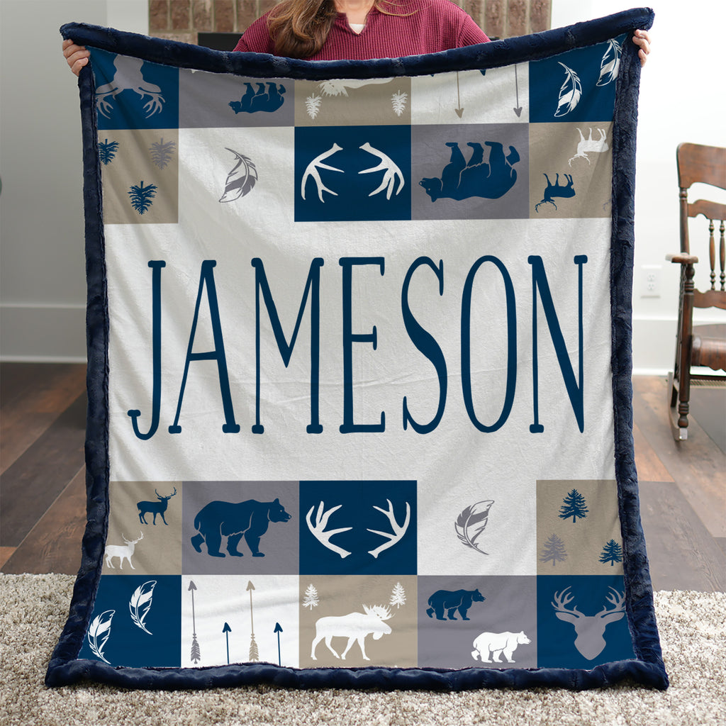 Woman holding personalized woodland minky blanket with navy trim