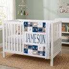 Personalized woodland minky blanket with white sherpa back draped over crib rail