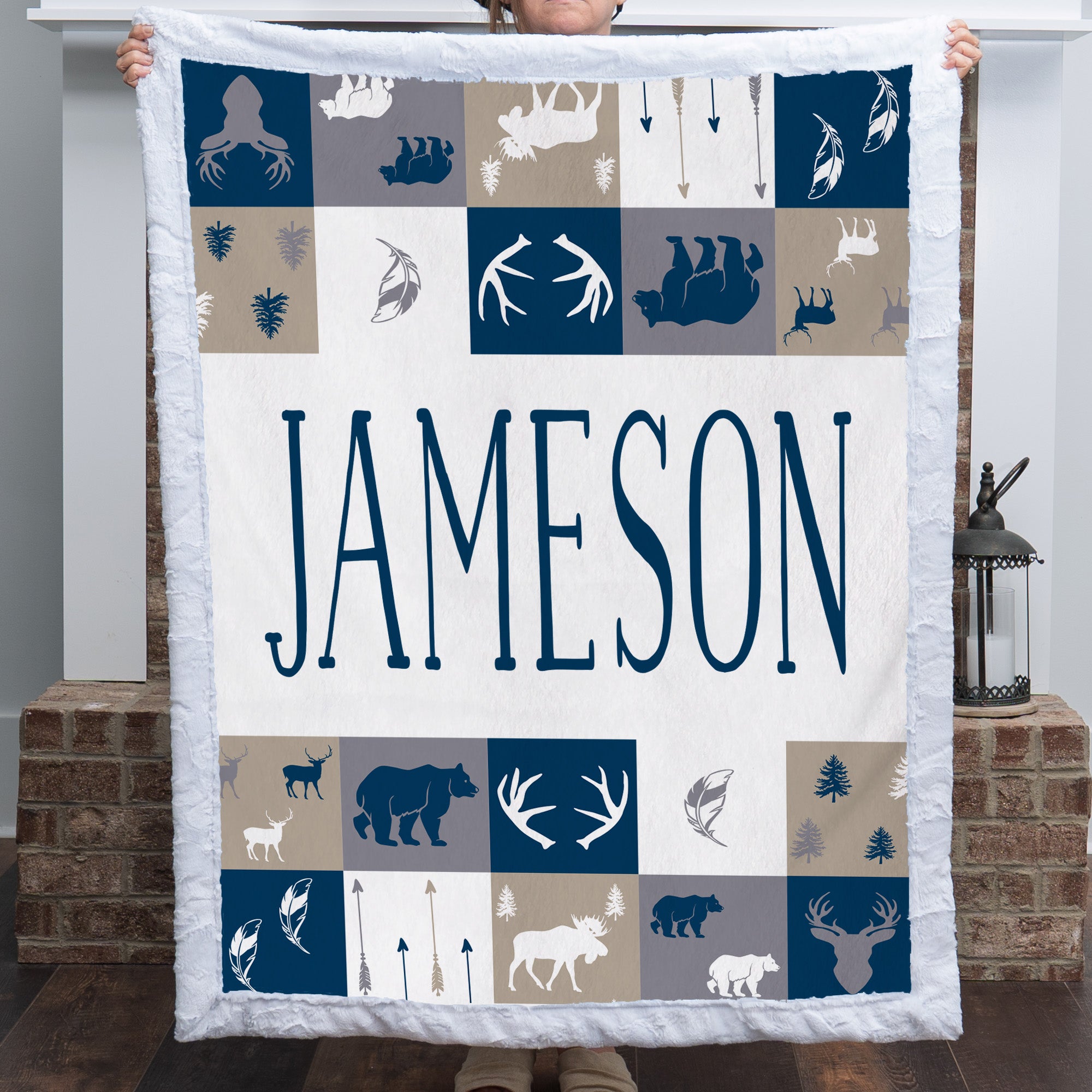 Woman holding personalized woodland minky blanket with white trim