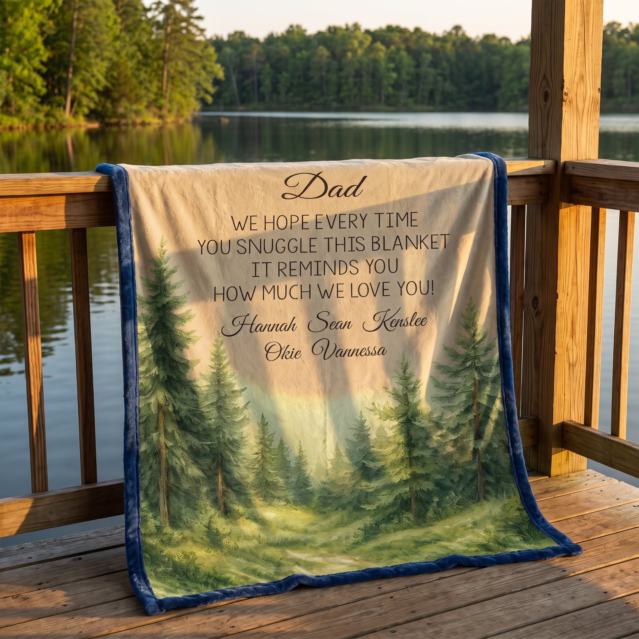 Personalized woodland minky throw for Dad on lakeside dock at sunset, blue border with pine forest scene