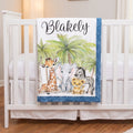 Personalized safari animal baby blanket with name draped over white crib rail
