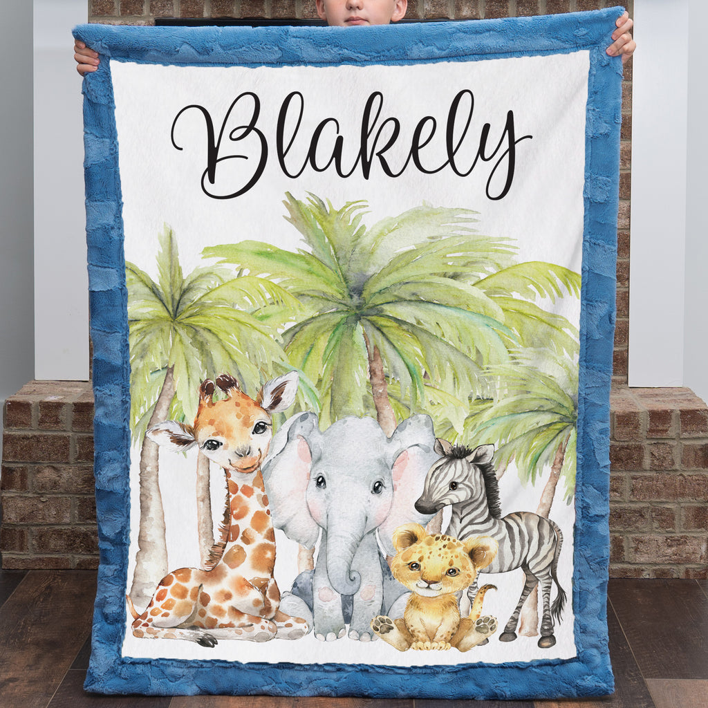 Boy holding up personalized safari animal minky baby blanket with name and jungle friends