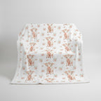 White blanket with pink pig pattern on a white background