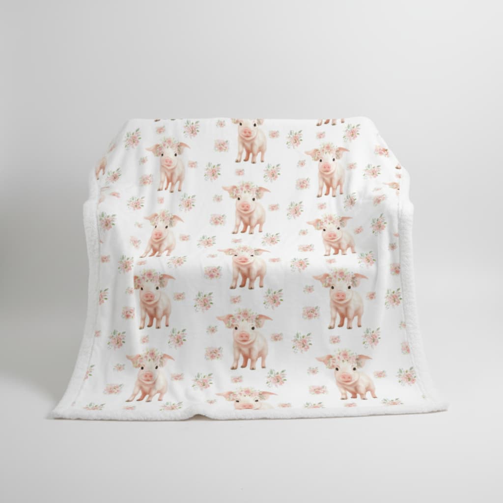 White blanket with pink pig pattern on a white background