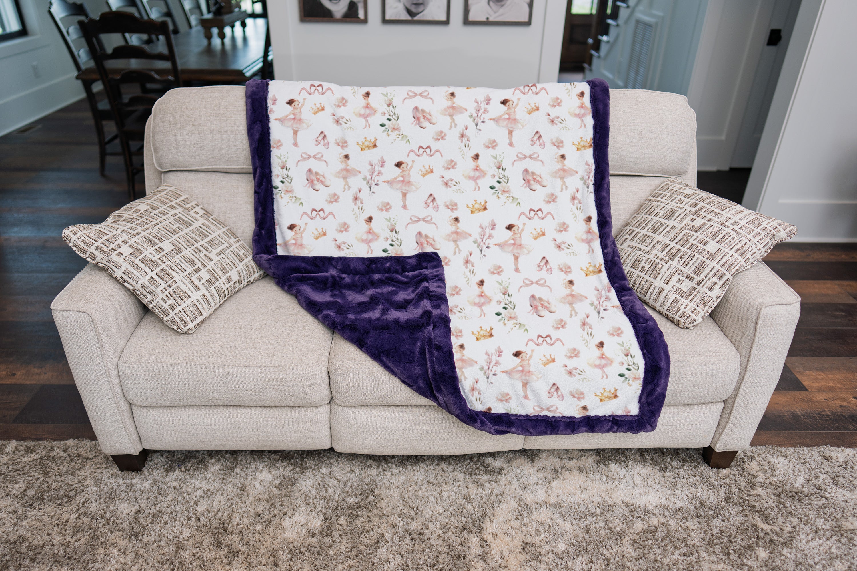 Sofa with a floral-patterned blanket draped over it in a living room setting.