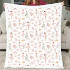 Person holding a blanket with ballerina pattern in a living room setting