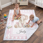 Toddlers playing with blocks on personalized elephant minky blanket in nursery