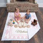 Toddlers playing with wooden toys on personalized pink pony minky blanket by fireplace
