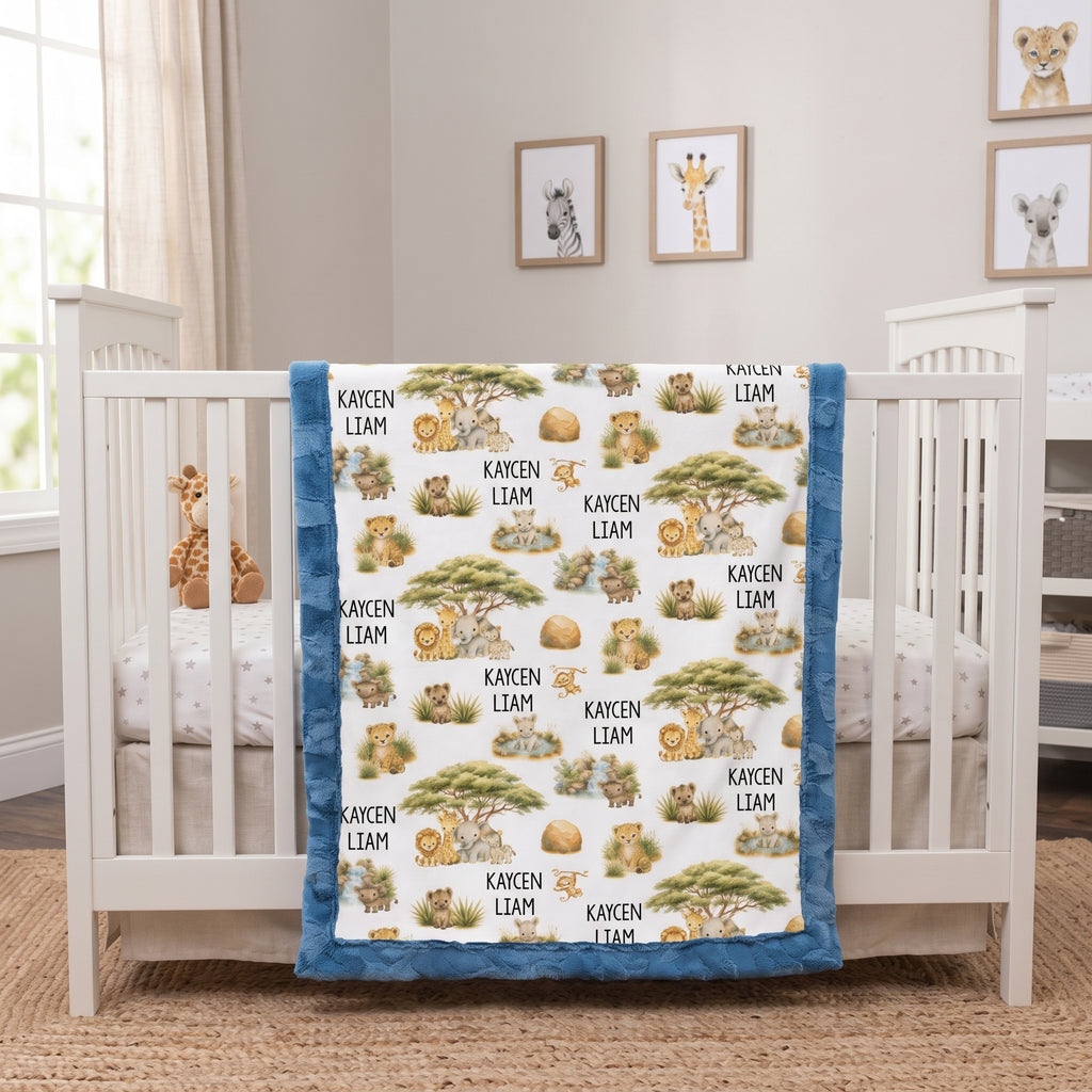 A custom safari-themed baby blanket with the name 'KAYSEN LIAM' printed repeatedly, draped over a white wooden crib in a bright nursery.