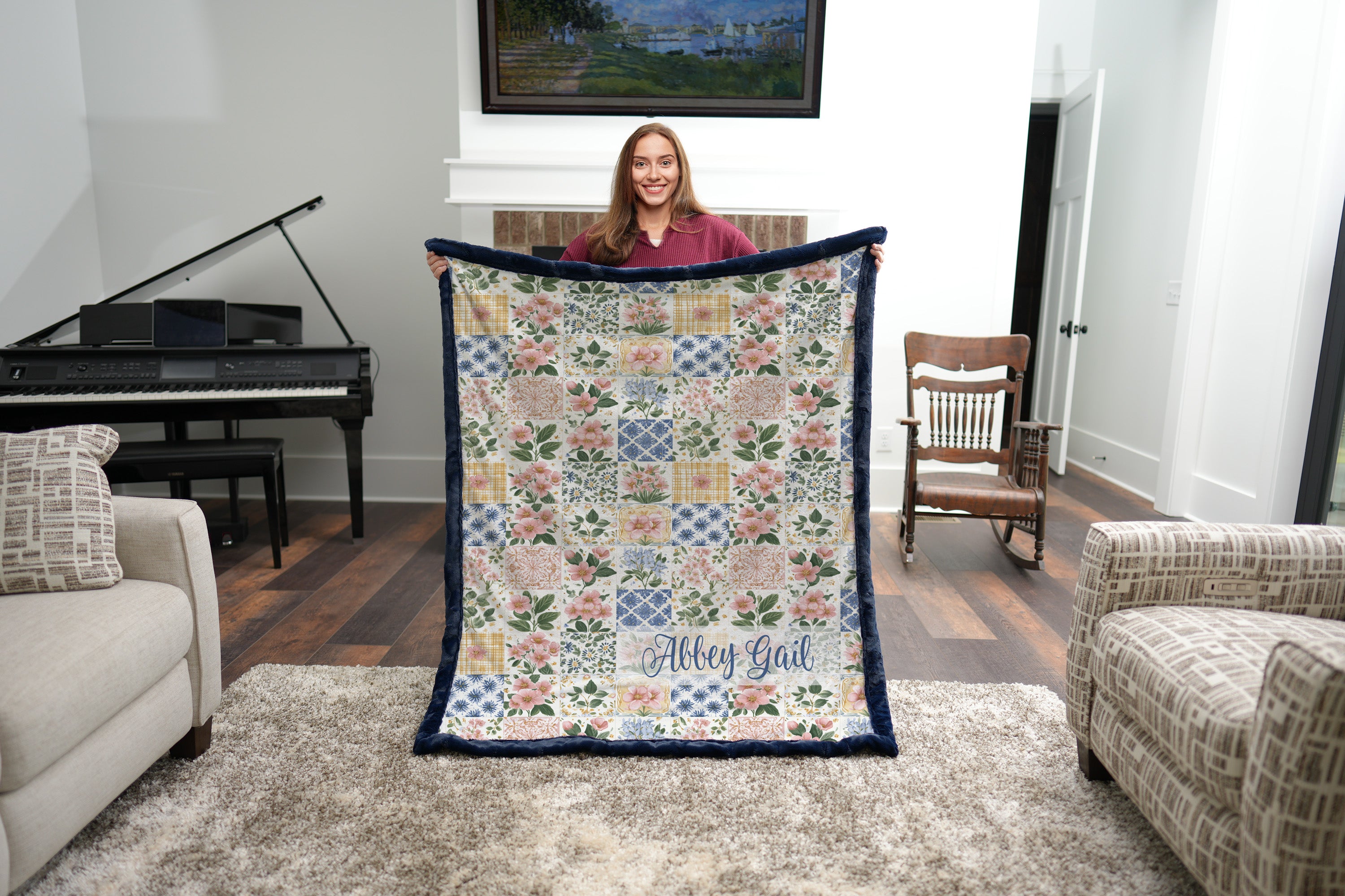 Corner detail of personalized floral patchwork blanket showing name in flowing script