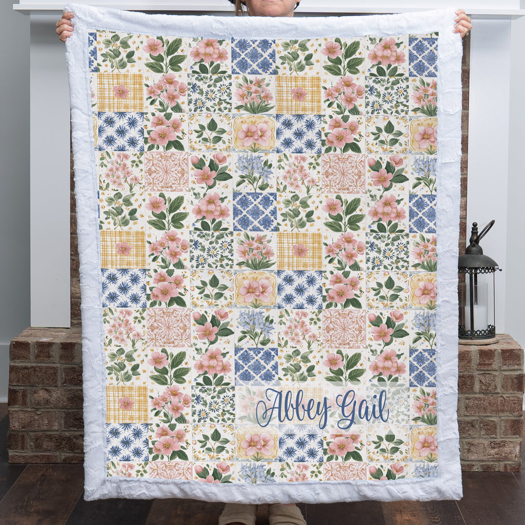 Personalized floral patchwork blanket with pink Luxe Cuddle Minky trim and name in script