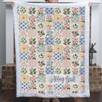 Personalized floral patchwork blanket with pink Luxe Cuddle Minky trim and name in script