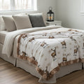 Winter elk minky blanket laid across bed in rustic woodland bedroom