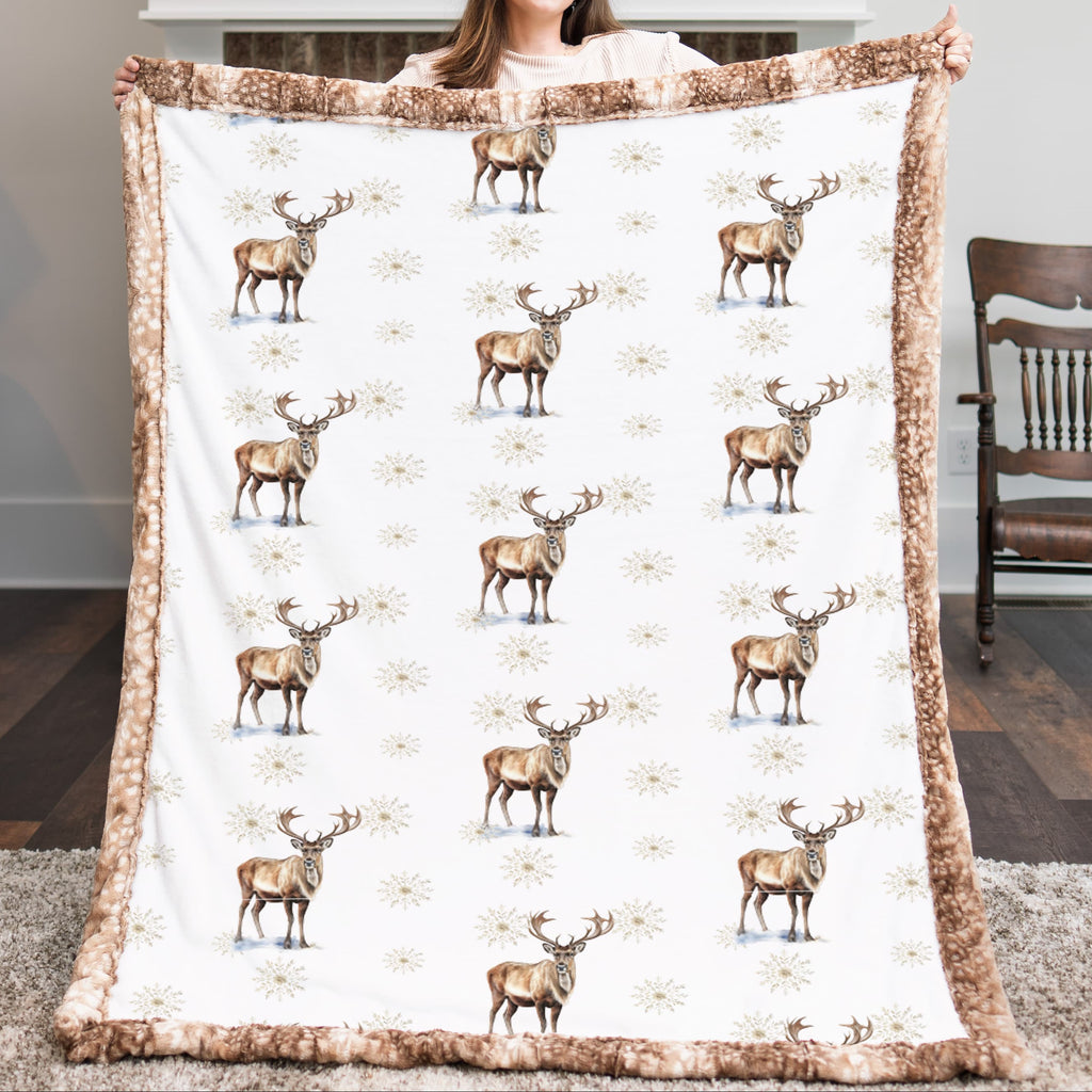 Woman holding winter elk minky blanket in a cozy living room