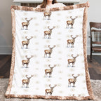 Woman holding winter elk minky blanket in a cozy living room
