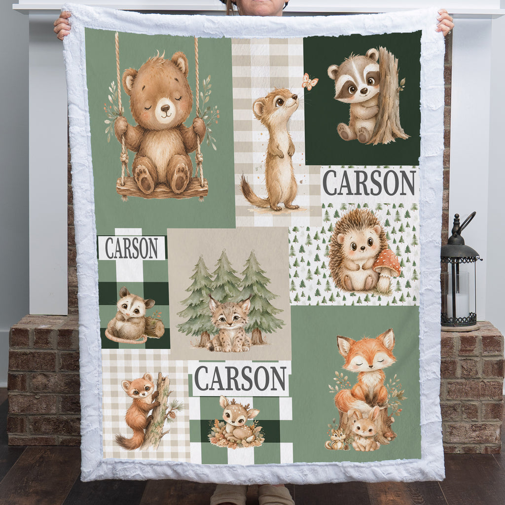 A custom quilted blanket featuring woodland animal illustrations and the name 'CARSON' printed in multiple patchwork panels, held up by a person in front of a brick fireplace.